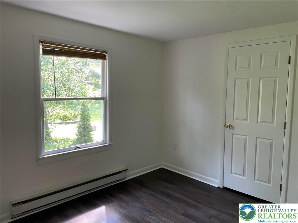 849 Weir Lake Road Kunkletown, PA 18058 - Photo 26 of 44 an empty room with wooden floor and windows