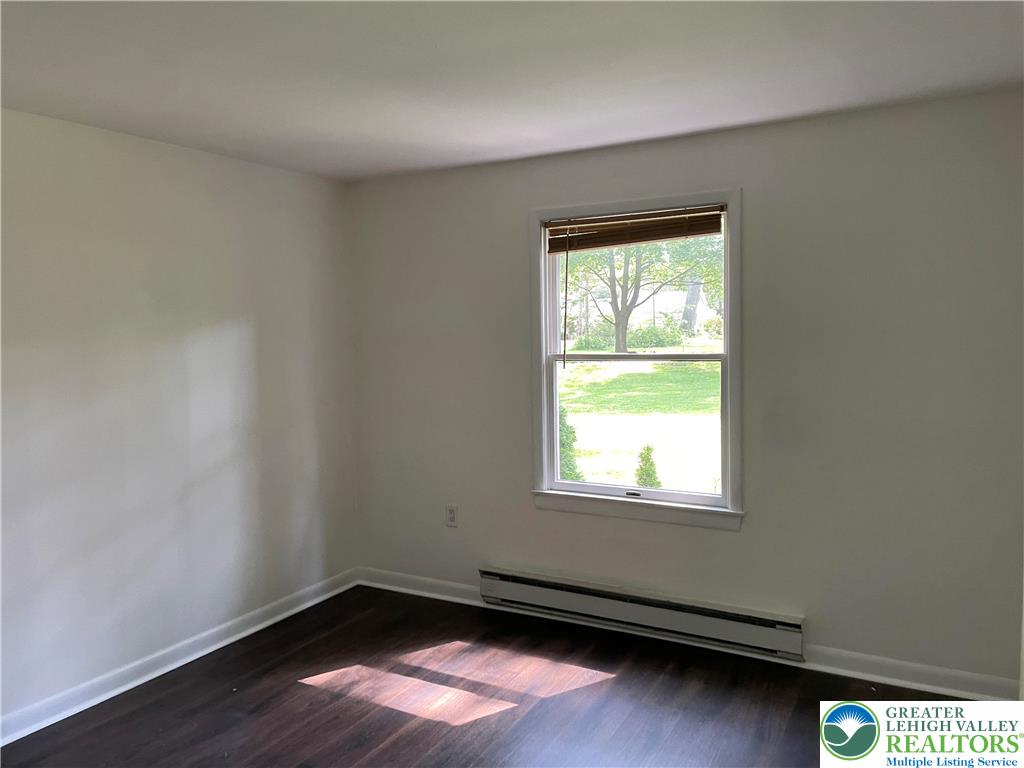 849 Weir Lake Road Kunkletown, PA 18058 - Photo 27 of 44 an empty room with wooden floor and windows