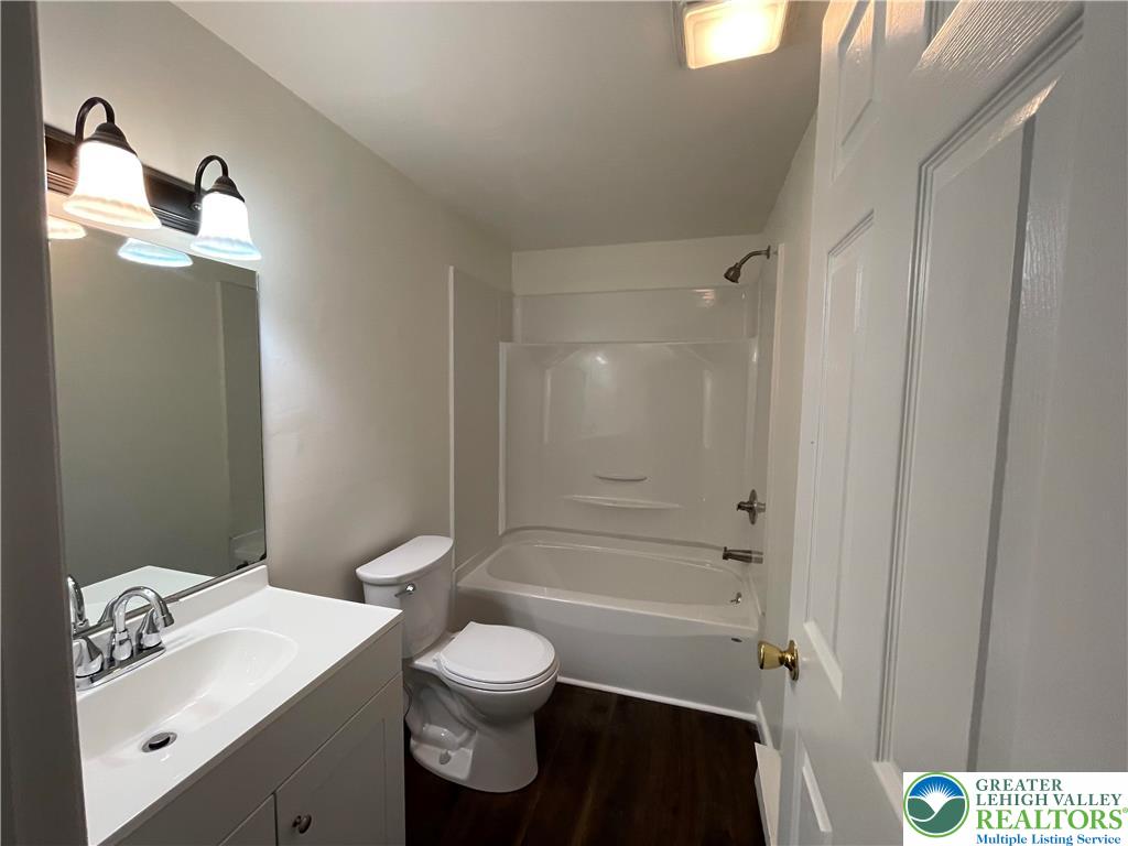 849 Weir Lake Road Kunkletown, PA 18058 - Photo 29 of 44 a bathroom with a toilet a sink a mirror and vanity