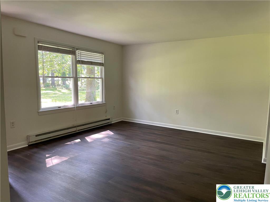 849 Weir Lake Road Kunkletown, PA 18058 - Photo 9 of 44 an empty room with wooden floor and windows