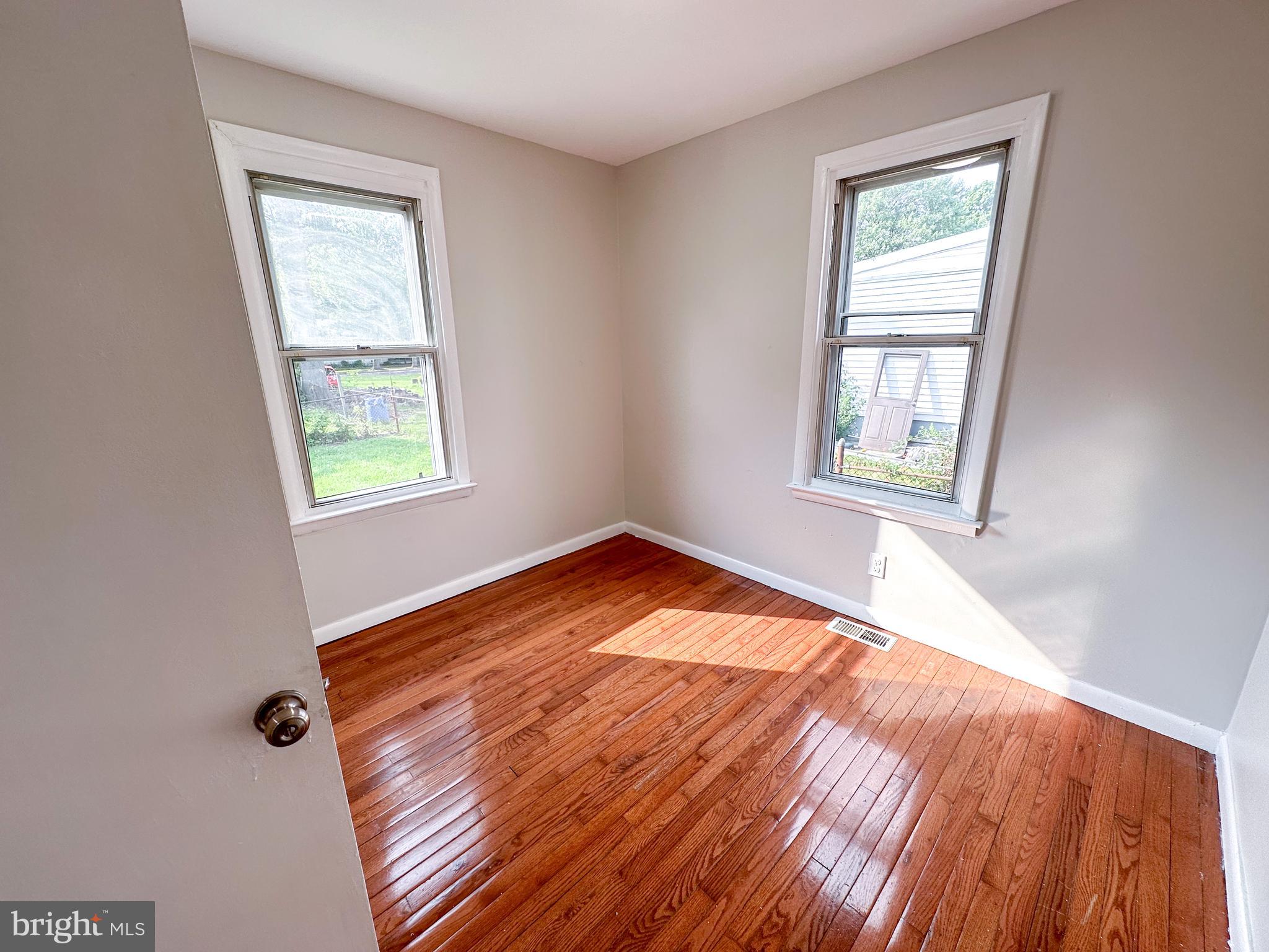 19 Lane Avenue, Unit 1 Gloucester City, NJ 08030 - Photo 12 of 18 an empty room with wooden floor and windows