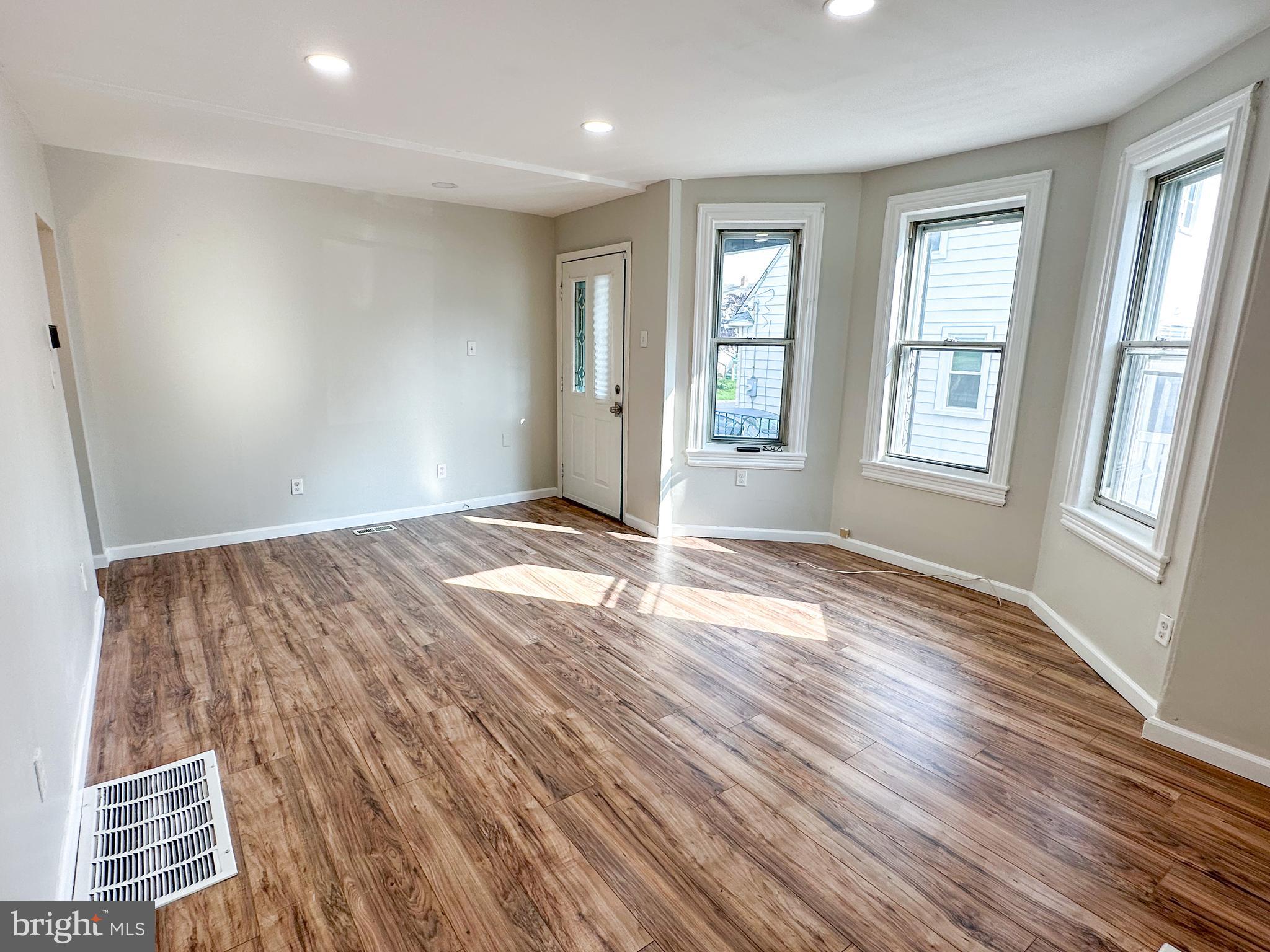 19 Lane Avenue, Unit 1 Gloucester City, NJ 08030 - Photo 7 of 18 an empty room with wooden floor and windows