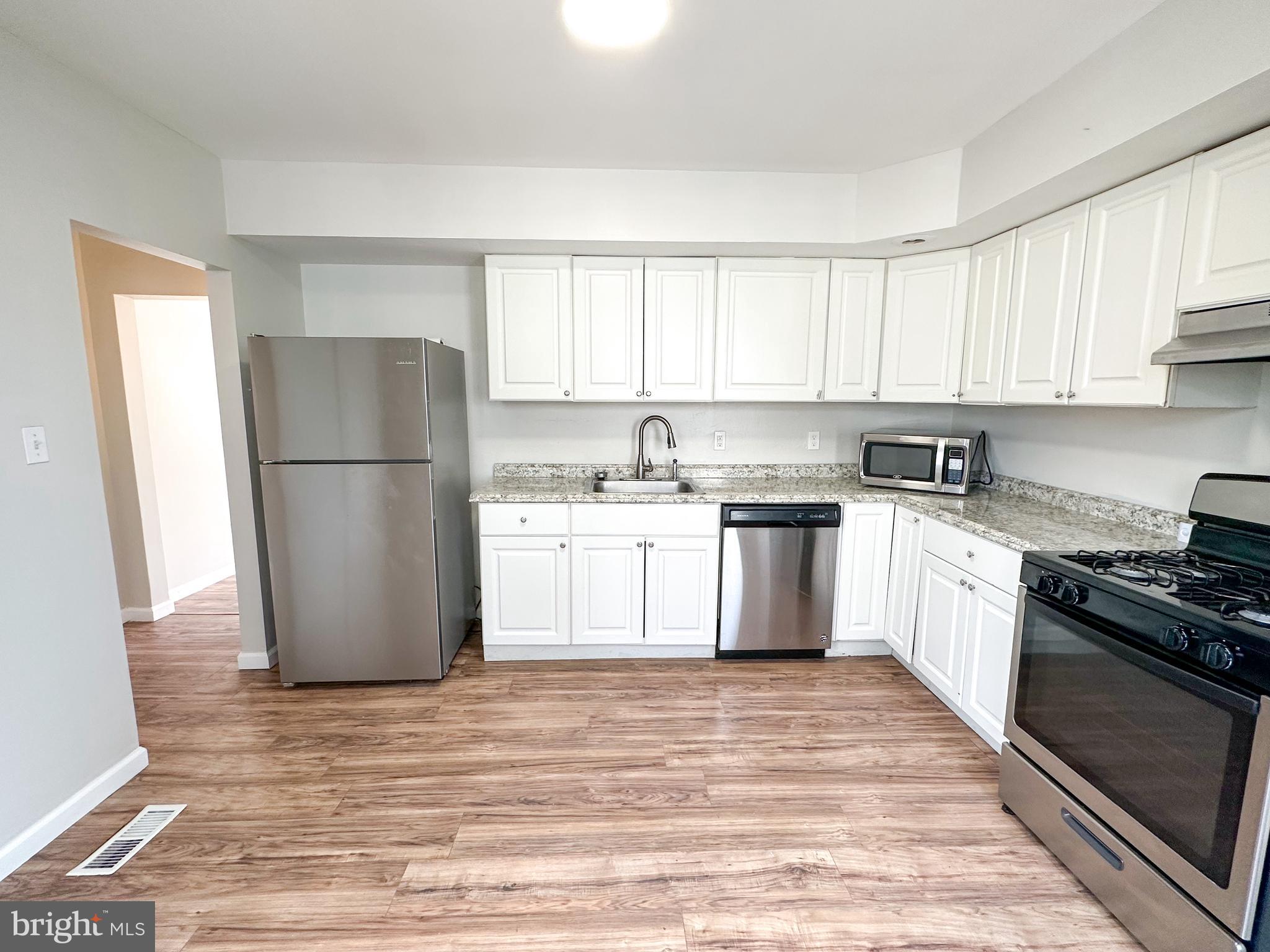 19 Lane Avenue, Unit 1 Gloucester City, NJ 08030 - Photo 8 of 18 a kitchen with a white cabinets and white appliances