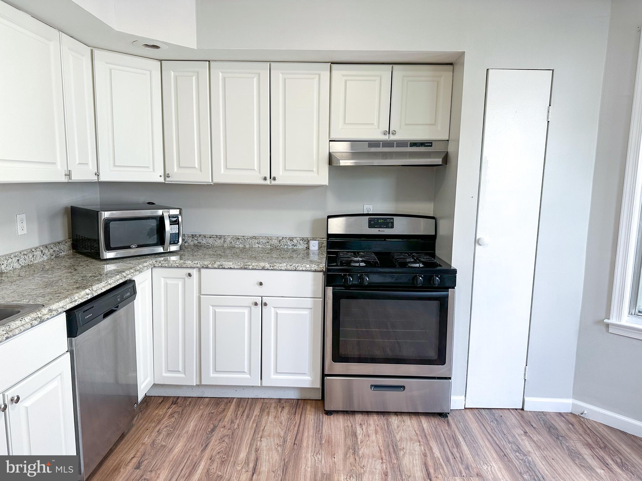 19 Lane Avenue, Unit 1 Gloucester City, NJ 08030 - Photo 9 of 18 a kitchen with granite countertop white cabinets and appliances