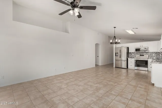 a view of a kitchen with a sink and refrigerator