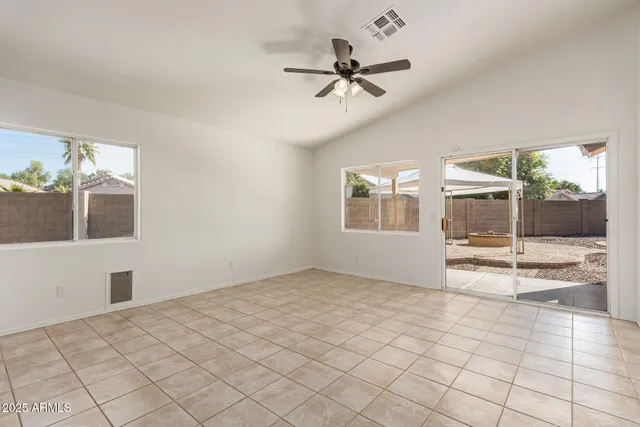 a view of a livingroom with a ceiling fan and window