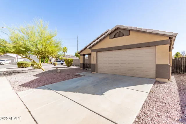 a view of a house with a yard and garage