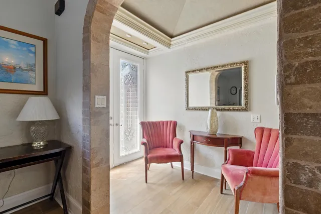 a living room with furniture a flat screen tv and a large window
