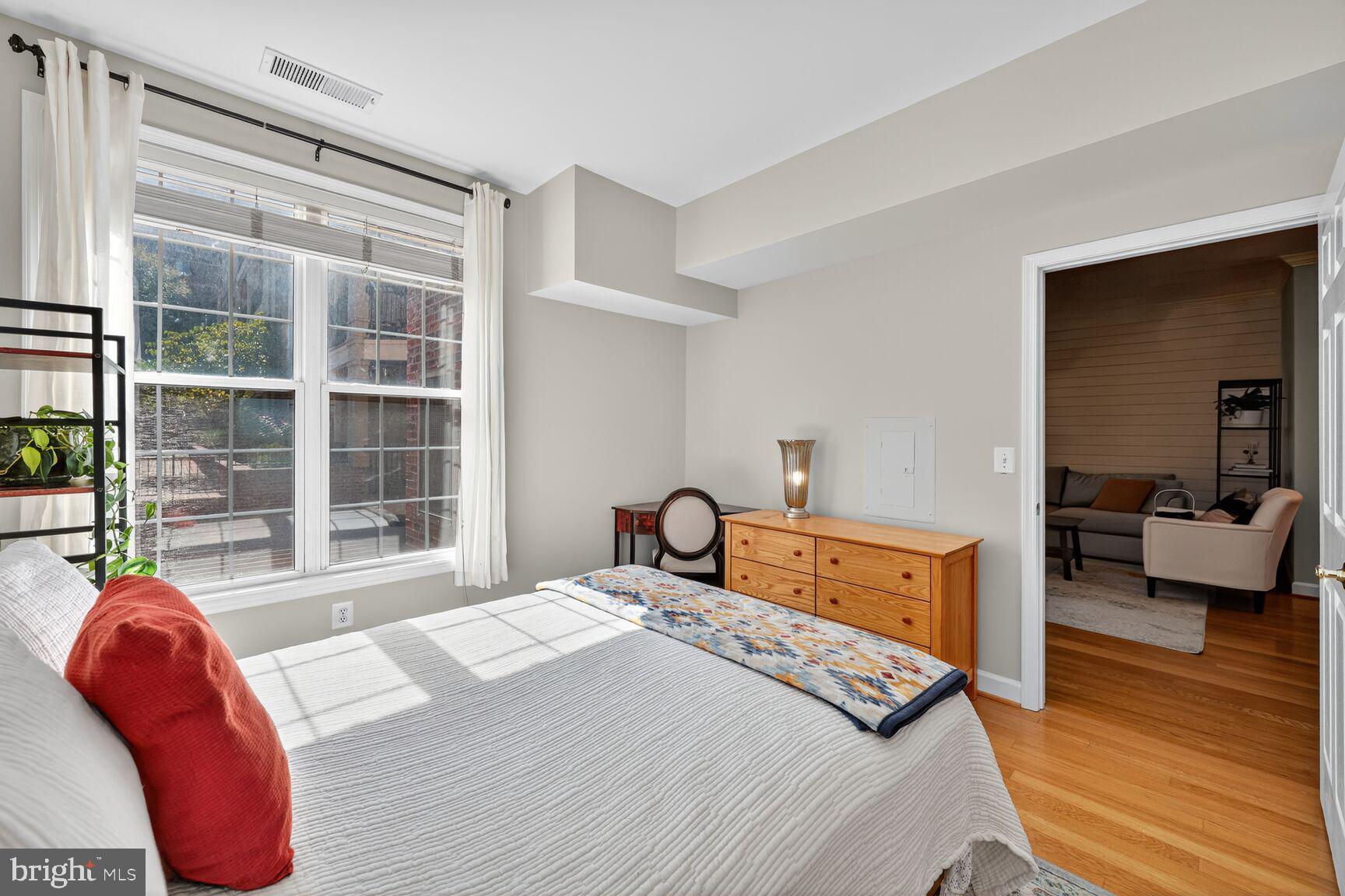 2330 14th Street North, Unit 205 Arlington, VA 22201 - Photo 12 of 29 a bedroom with a bed and wooden floor