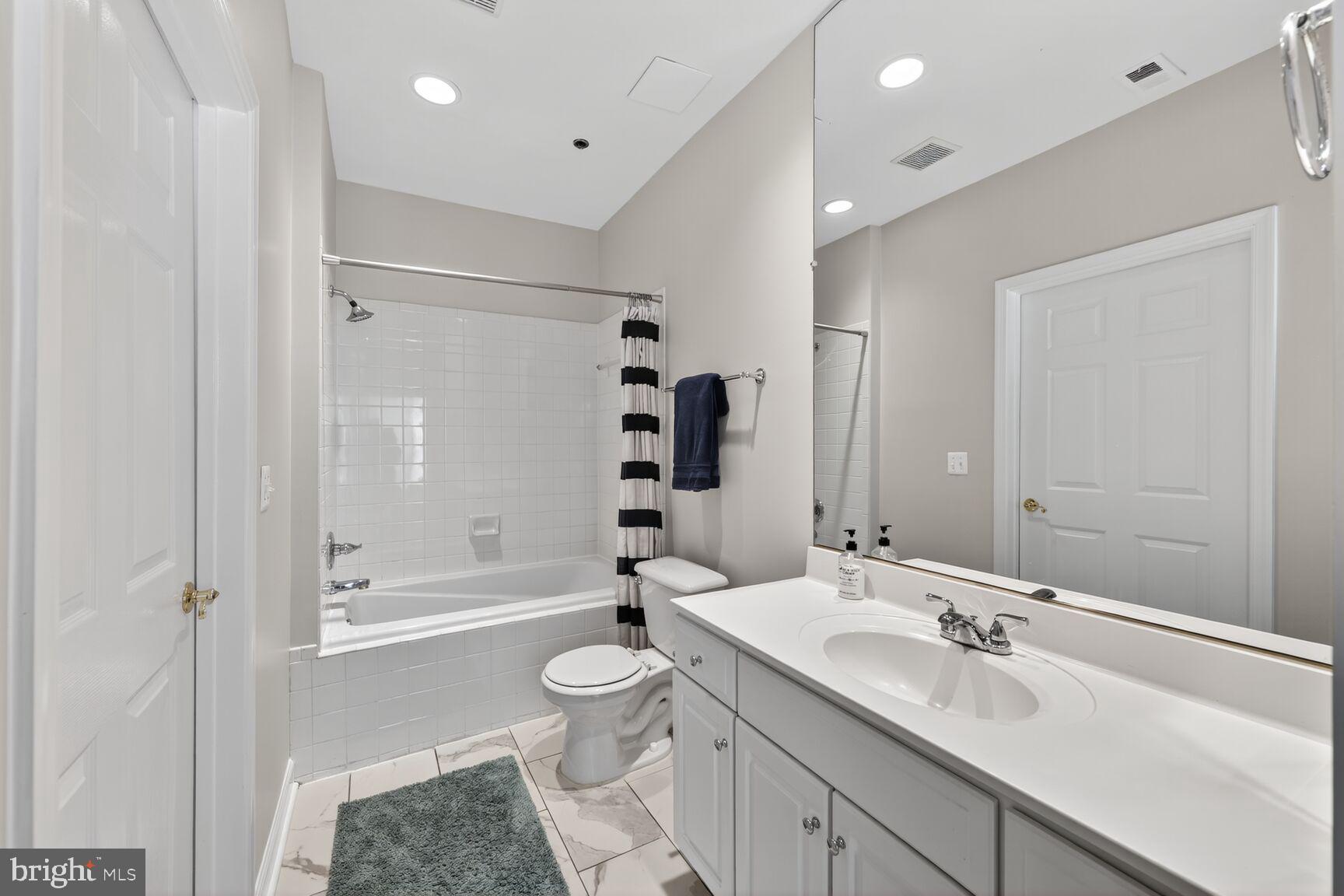 2330 14th Street North, Unit 205 Arlington, VA 22201 - Photo 14 of 29 a bathroom with a sink a toilet and shower