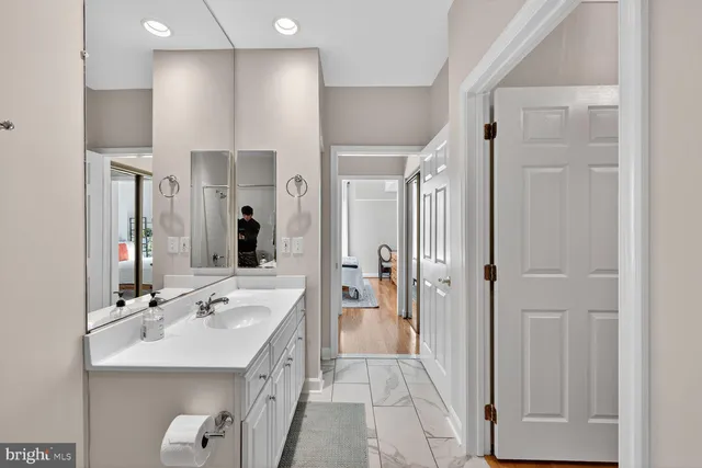 a spacious bathroom with a double vanity sink a mirror and shower