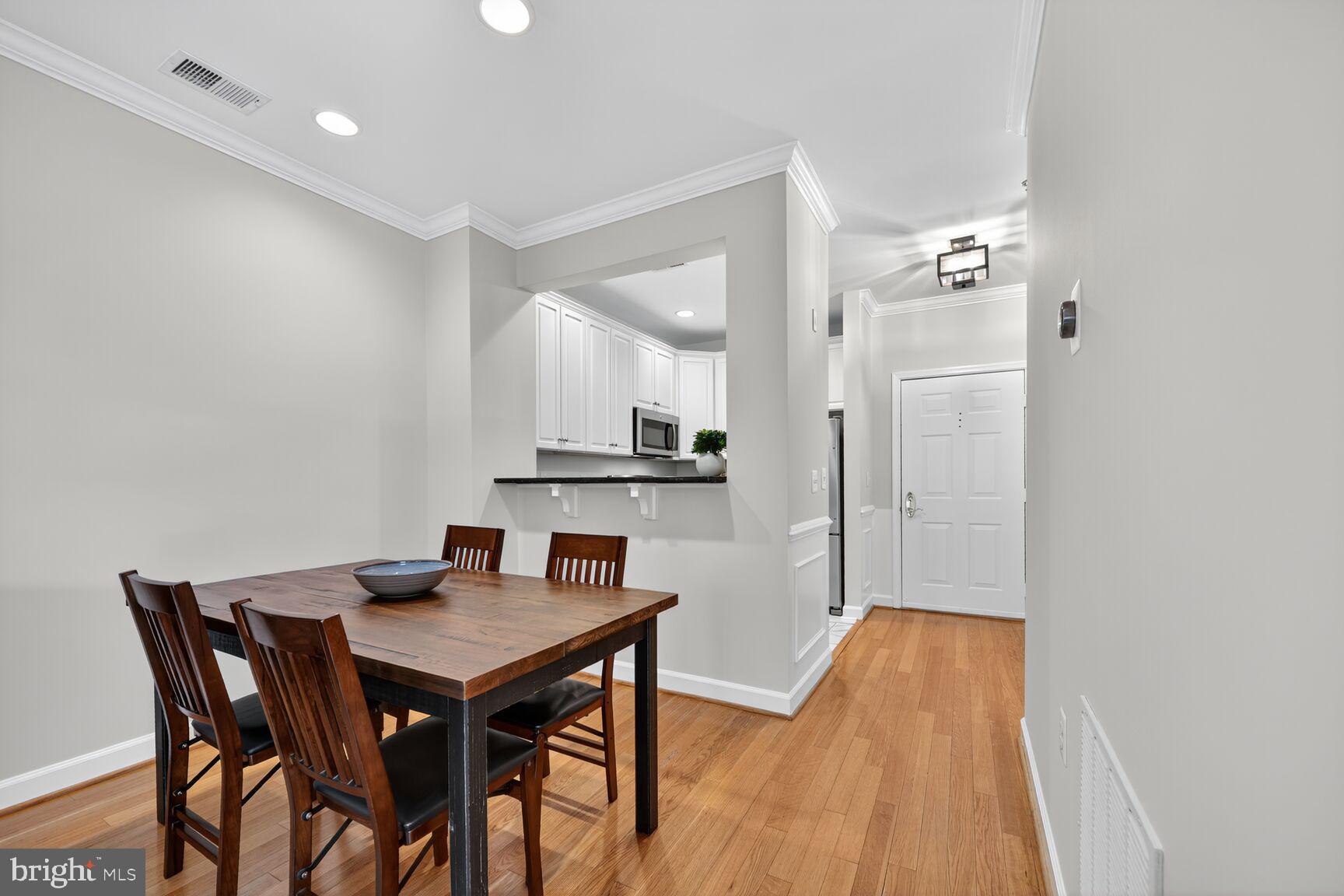 2330 14th Street North, Unit 205 Arlington, VA 22201 - Photo 10 of 29 a view of a dining room with furniture and wooden floor