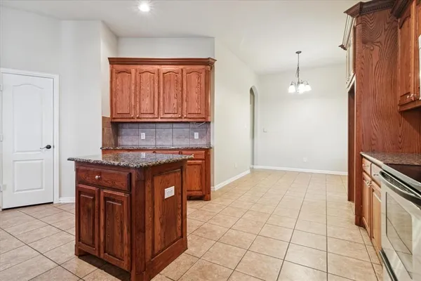 a kitchen with stainless steel appliances granite countertop a stove and a sink