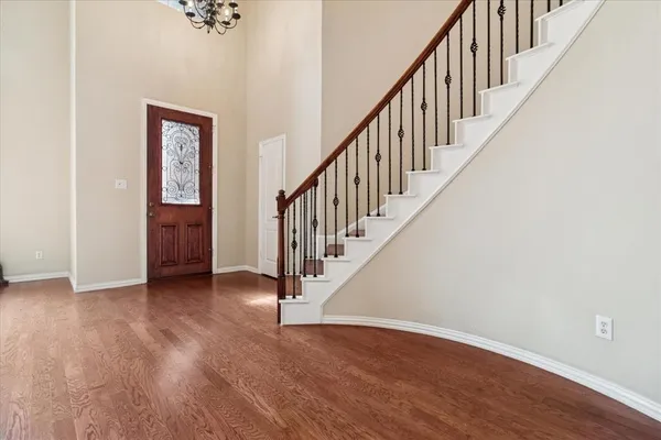 a view of an entryway with wooden floor