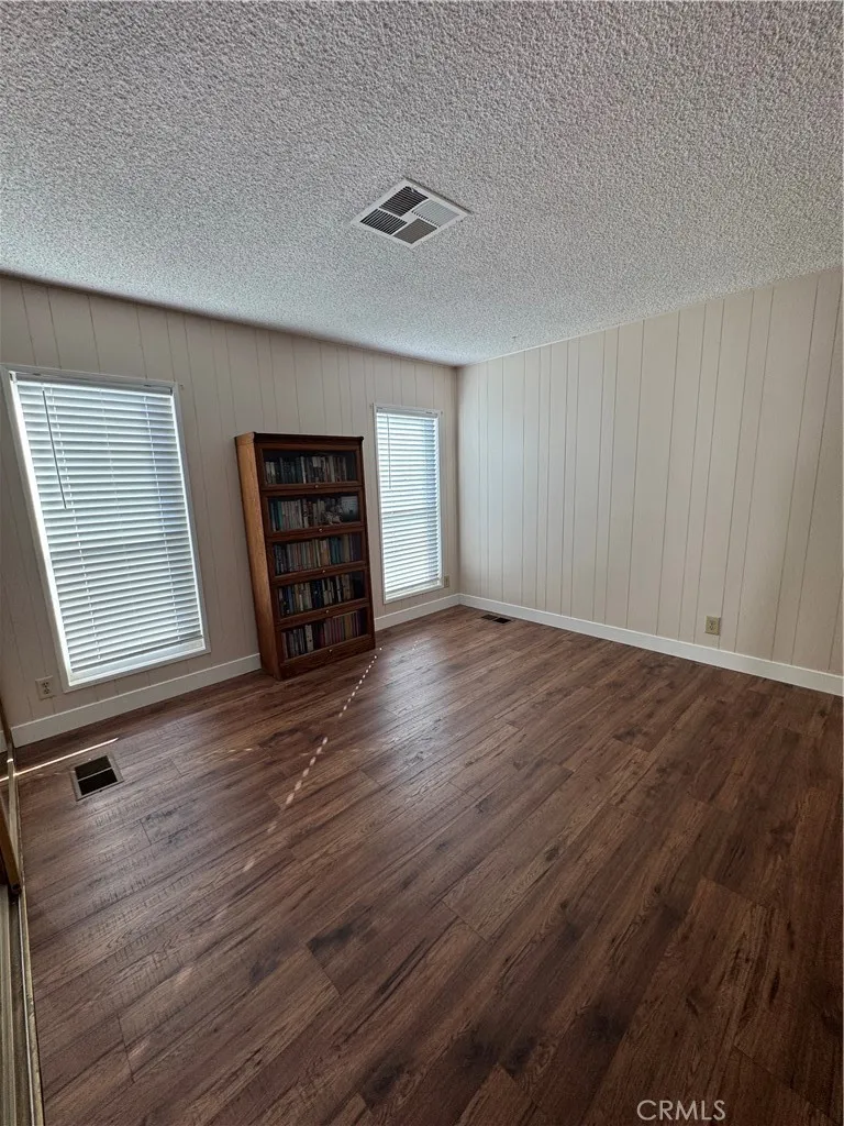 8651 Foothill, Unit 157 Rancho Cucamonga, CA 91730 - Photo 11 of 19 an empty room with wooden floor and windows