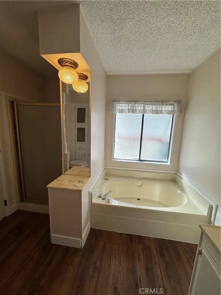 8651 Foothill, Unit 157 Rancho Cucamonga, CA 91730 - Photo 15 of 19 a bathroom with a tub sink and mirror
