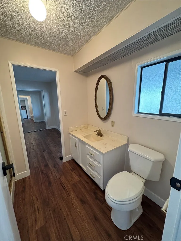 8651 Foothill, Unit 157 Rancho Cucamonga, CA 91730 - Photo 17 of 19 a bathroom with a toilet sink and mirror