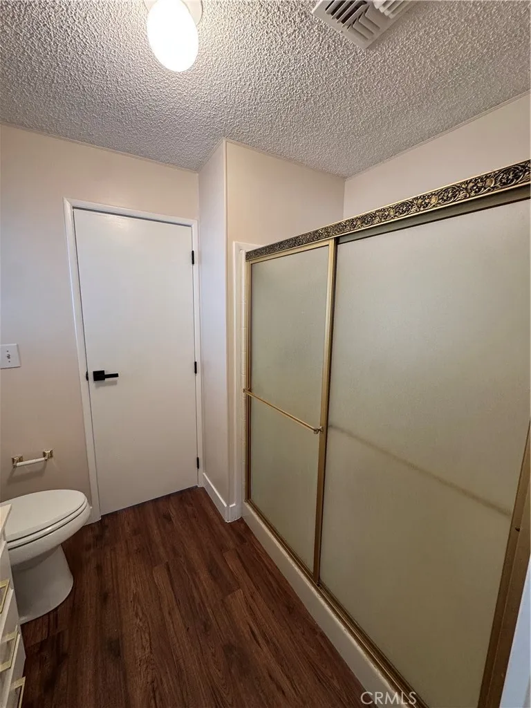 8651 Foothill, Unit 157 Rancho Cucamonga, CA 91730 - Photo 18 of 19 a bathroom with a granite countertop shower and a toilet