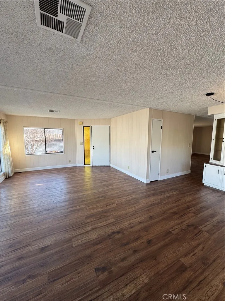 8651 Foothill, Unit 157 Rancho Cucamonga, CA 91730 - Photo 4 of 19 a view of empty room with wooden floor and fan