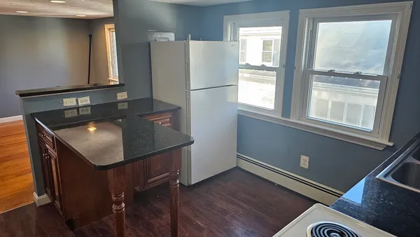 a kitchen with kitchen island a counter top space and a sink