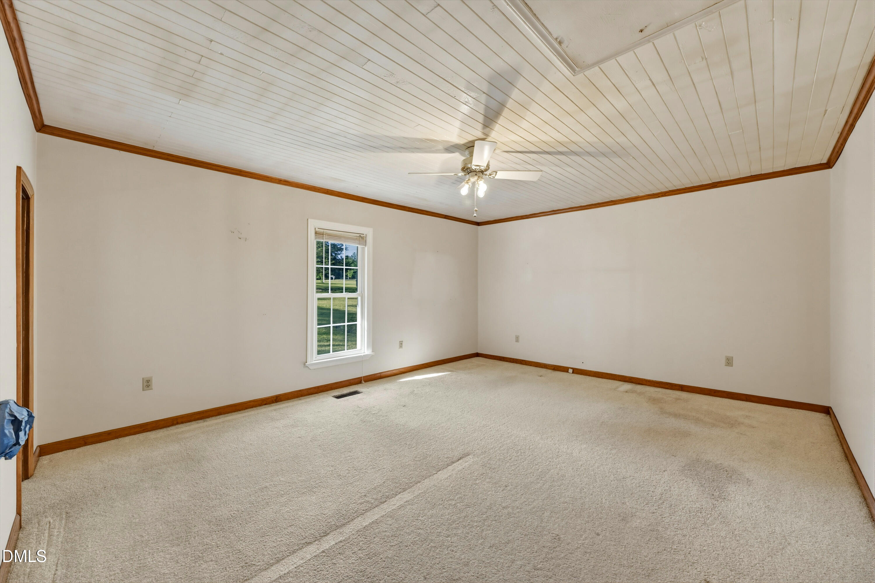 50 Robert Sledge Road Spring Hope, NC 27882 - Photo 10 of 50 an empty room with a chandelier fan and windows