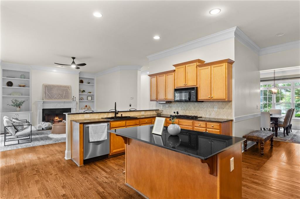 5765 Bailey Ridge Court Duluth, GA 30097 - Photo 12 of 53 a kitchen with stainless steel appliances granite countertop a sink stove and wooden cabinets