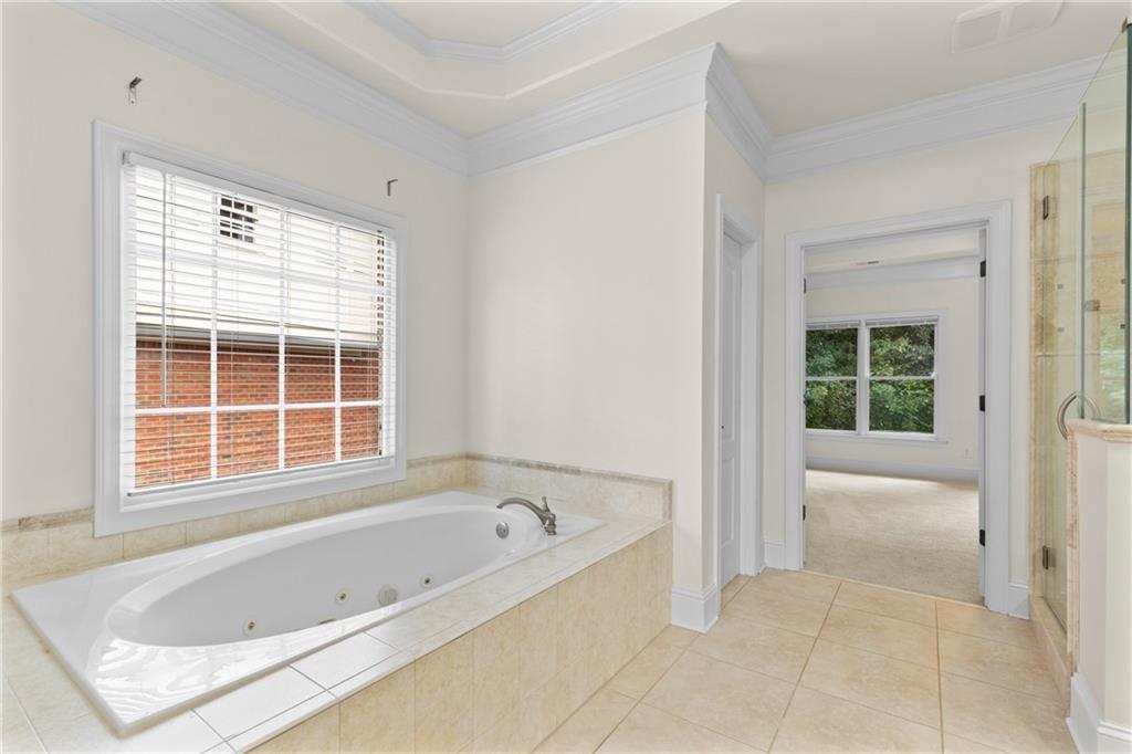 5765 Bailey Ridge Court Duluth, GA 30097 - Photo 29 of 53 a bathroom with a bathtub and a shower