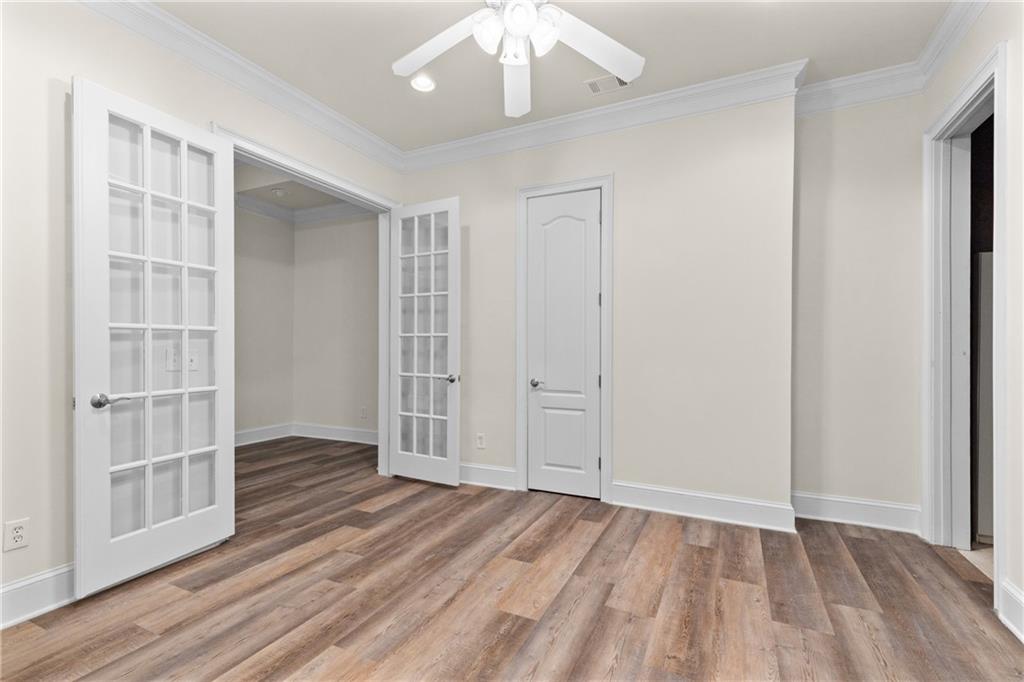 5765 Bailey Ridge Court Duluth, GA 30097 - Photo 43 of 53 an empty room with wooden floor closet and windows