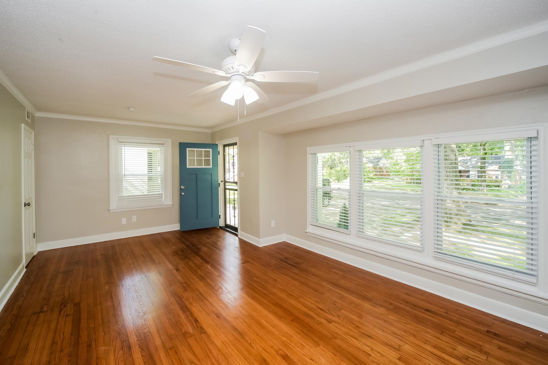 989 Wingfield Road Memphis, TN 38122 - Photo 3 of 15 a view of an empty room with wooden floor and a window