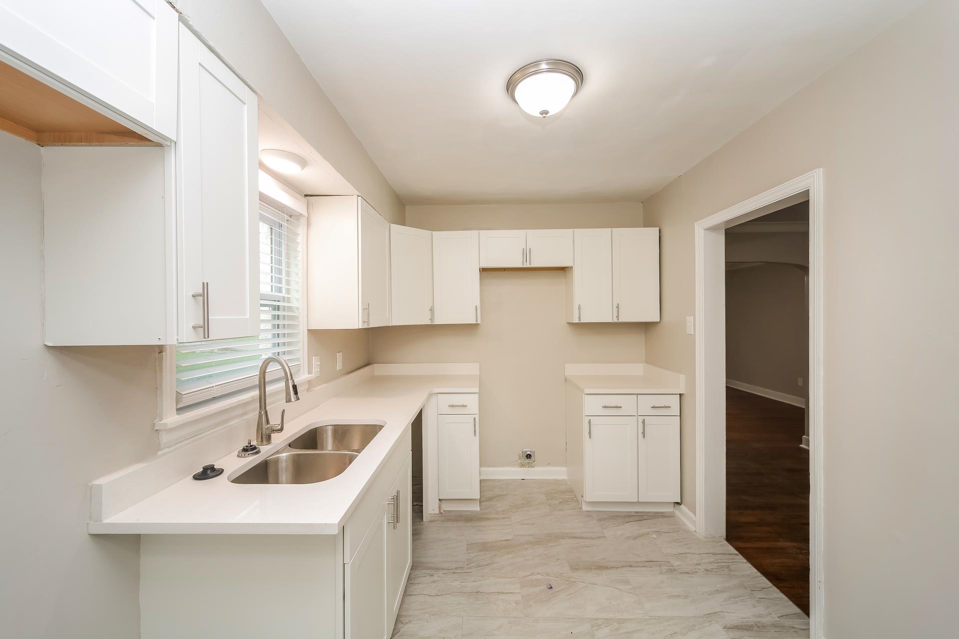 989 Wingfield Road Memphis, TN 38122 - Photo 7 of 15 a kitchen with sink a refrigerator and cabinets