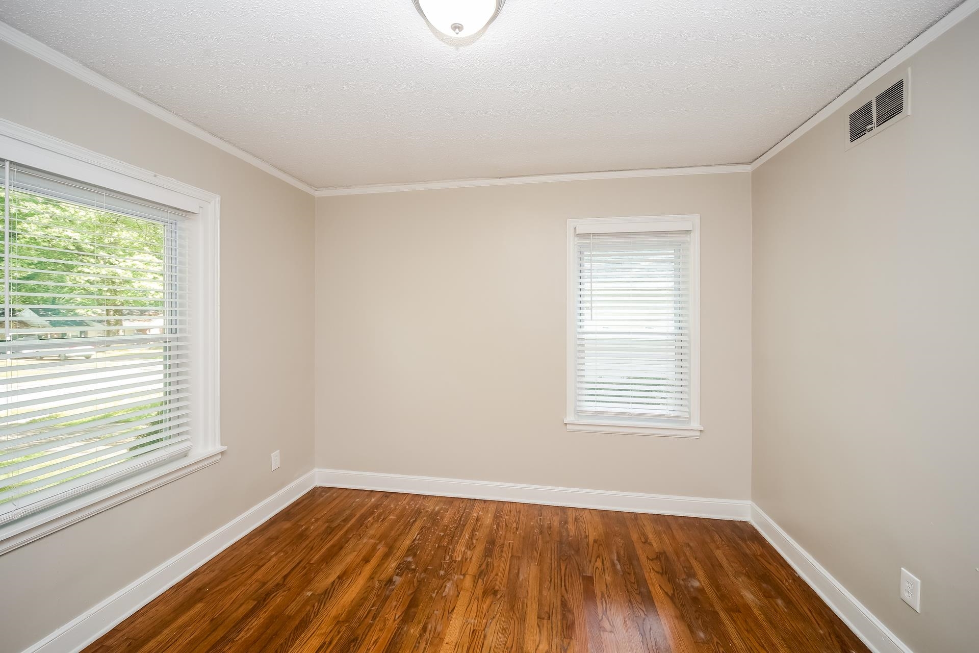 989 Wingfield Road Memphis, TN 38122 - Photo 10 of 15 a view of an empty room with wooden floor and a window
