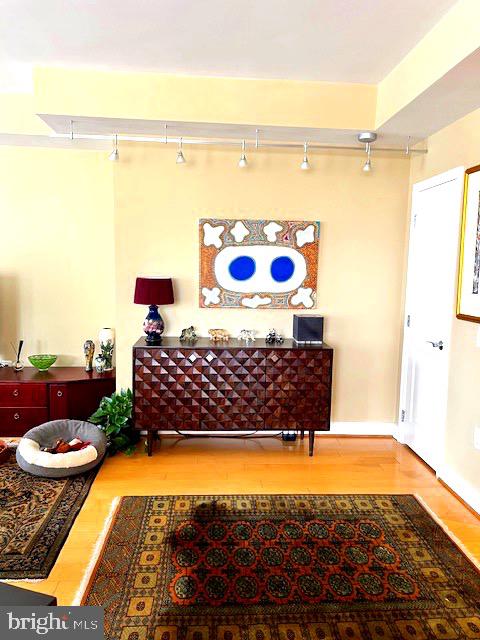 7710 Woodmont Avenue, Unit 911 Bethesda, MD 20814 - Photo 11 of 25 a living room with a rug and a couch