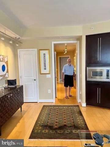 a bedroom with wooden floor and furniture