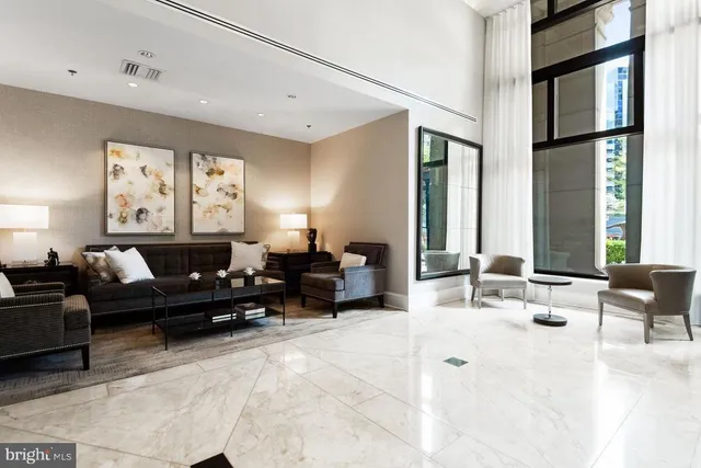 a living room with furniture and large windows