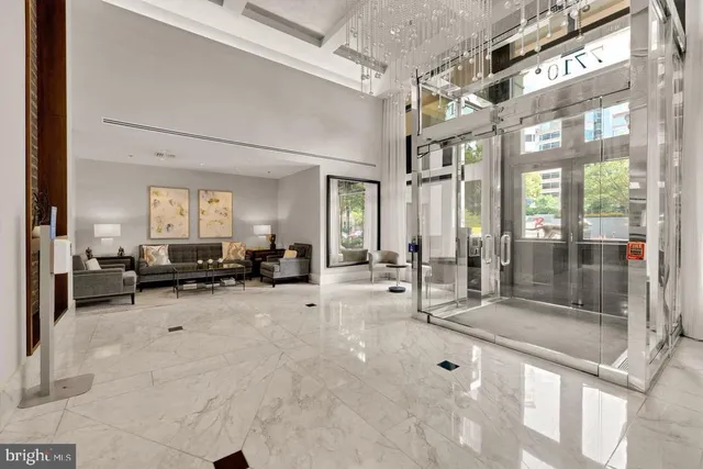 a lobby with furniture and a glass door