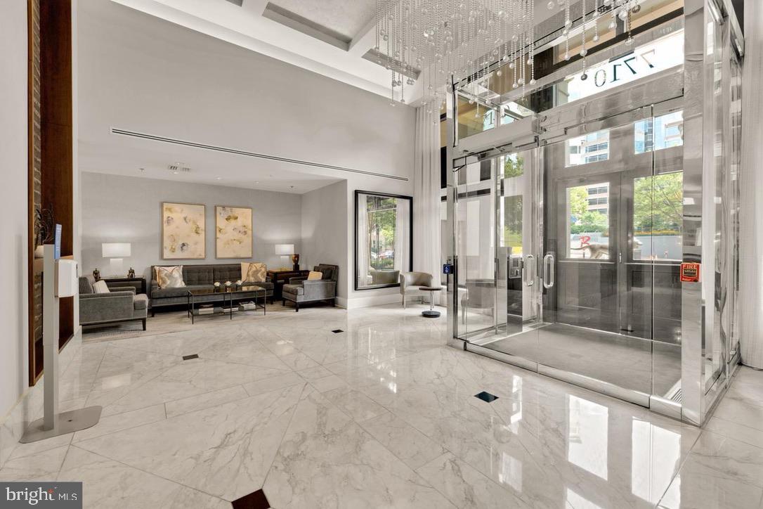 7710 Woodmont Avenue, Unit 911 Bethesda, MD 20814 - Photo 19 of 25 a lobby with furniture and a glass door