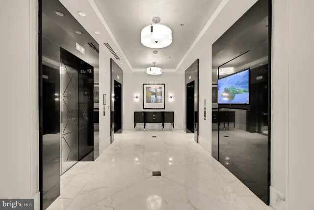 a view of a hallway with living room and dining room