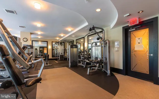 a room with lots of chairs and mirrors