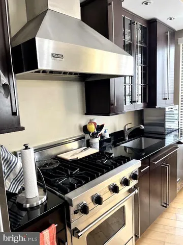 a stove top oven sitting inside of a kitchen