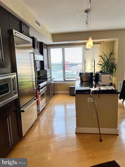 7710 Woodmont Avenue, Unit 911 Bethesda, MD 20814 - Photo 8 of 25 a living room with stainless steel appliances kitchen island granite countertop a refrigerator a sink and a stove