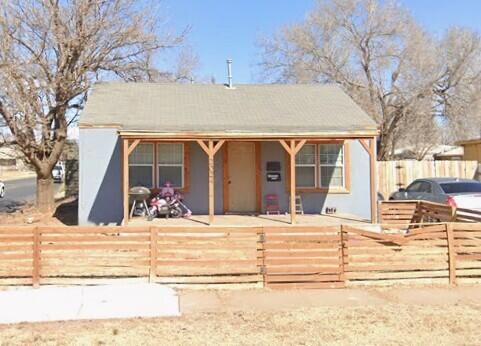 a view of a house with snow on the side of road