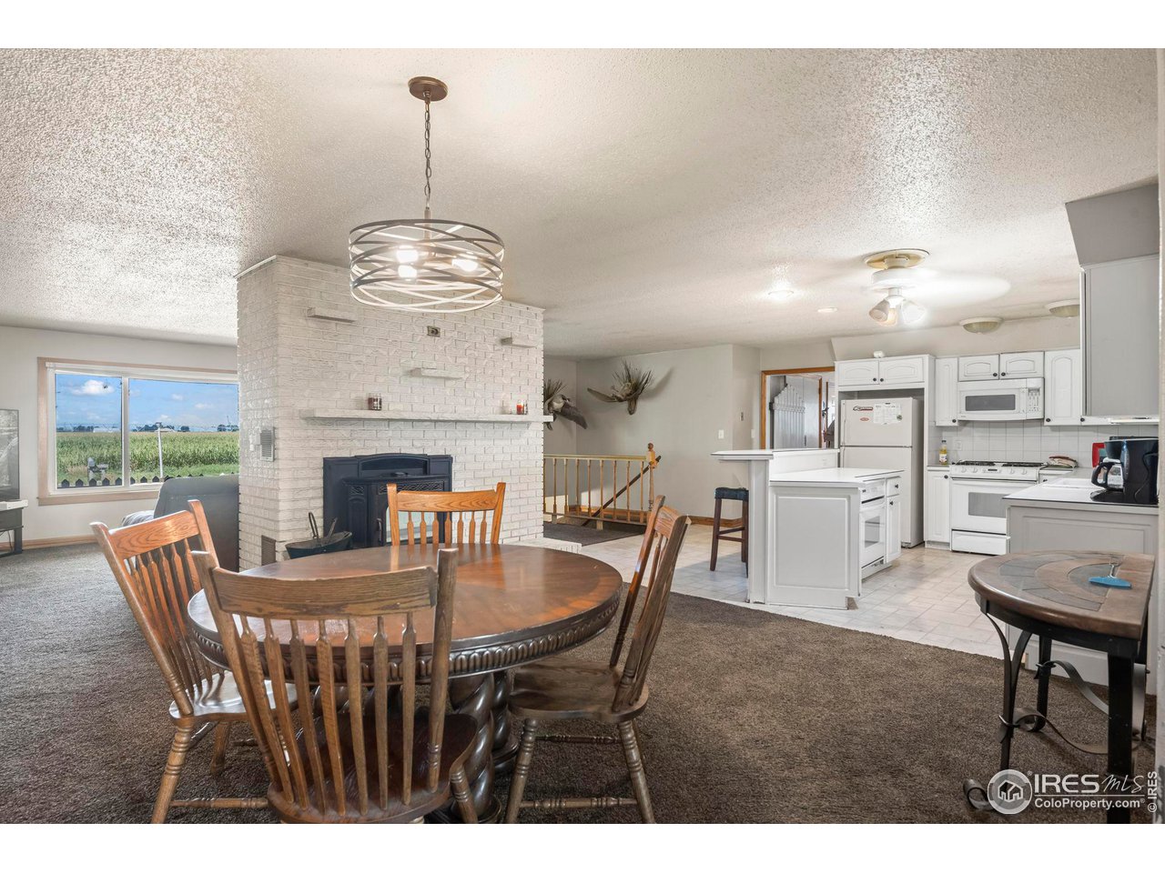 32864 County Road 49 Greeley, CO 80631 - Photo 12 of 40 a dining room with furniture a chandelier and wooden floor
