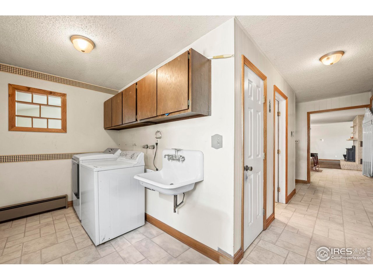 32864 County Road 49 Greeley, CO 80631 - Photo 13 of 40 a view of a hallway with bathroom and wooden floor