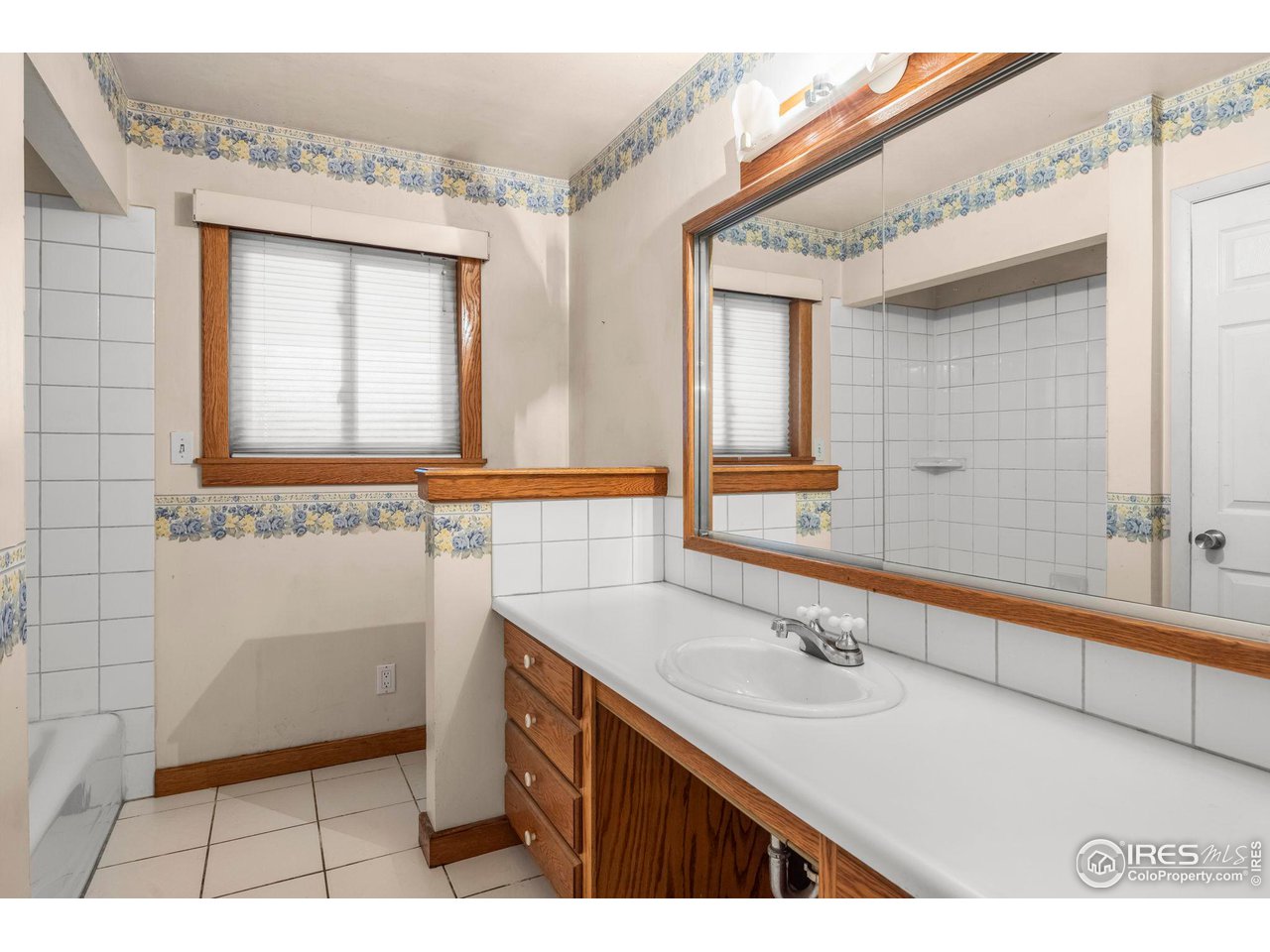 32864 County Road 49 Greeley, CO 80631 - Photo 21 of 40 a bathroom with a sink a mirror and a bathtub