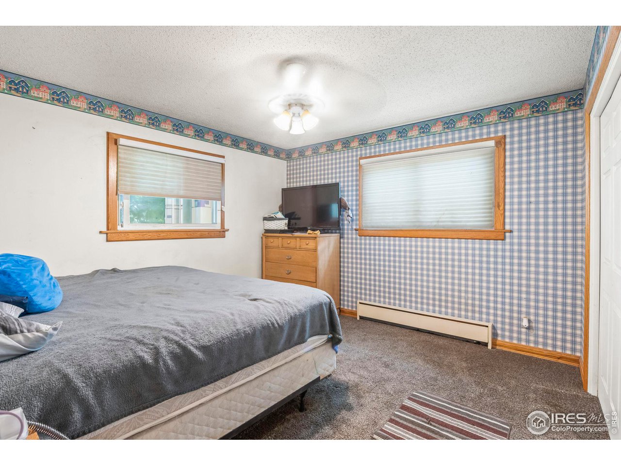 32864 County Road 49 Greeley, CO 80631 - Photo 22 of 40 a bedroom with a bed and a flat screen tv