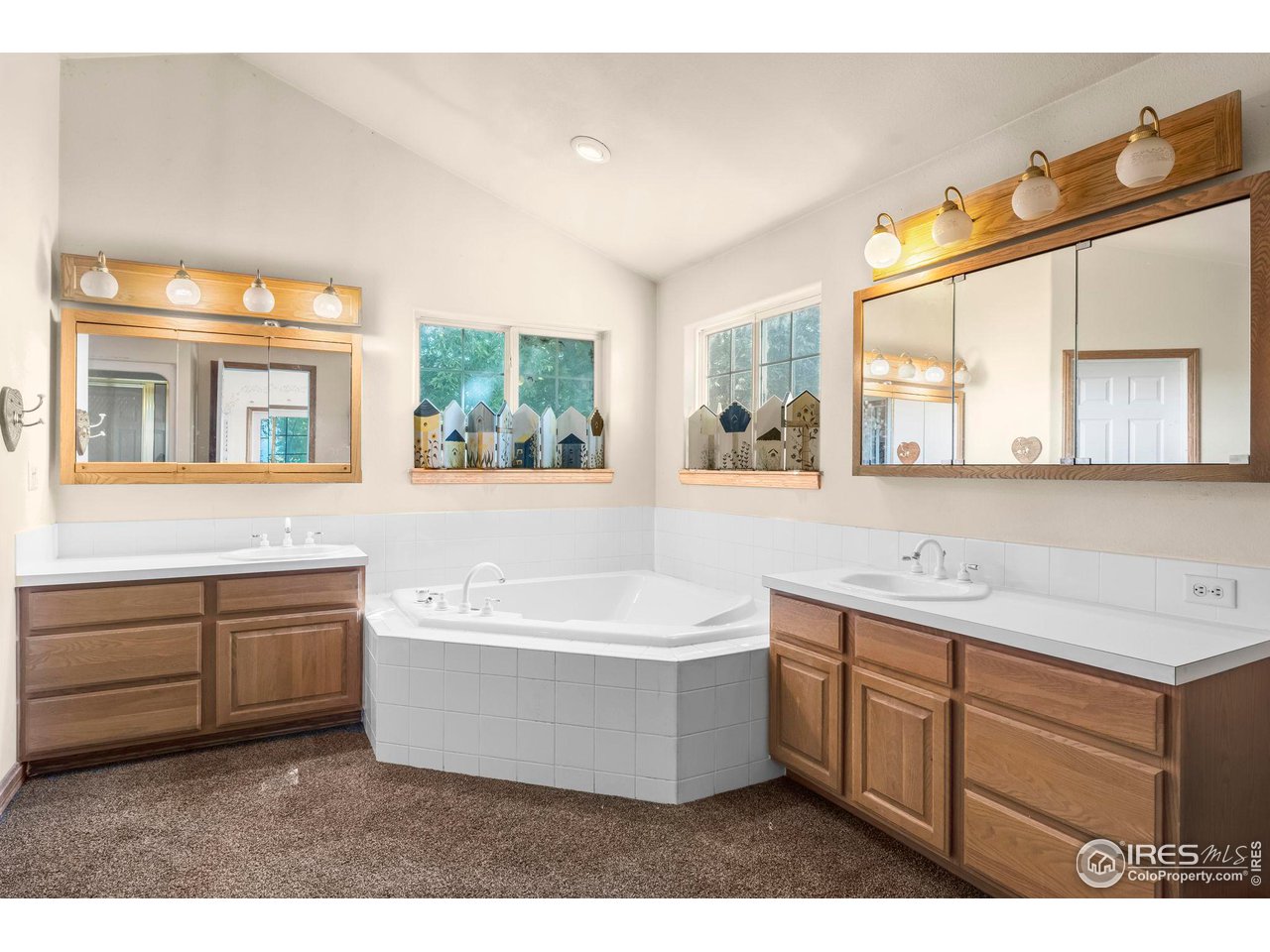 32864 County Road 49 Greeley, CO 80631 - Photo 23 of 40 a spacious bathroom with a tub double sink and mirror