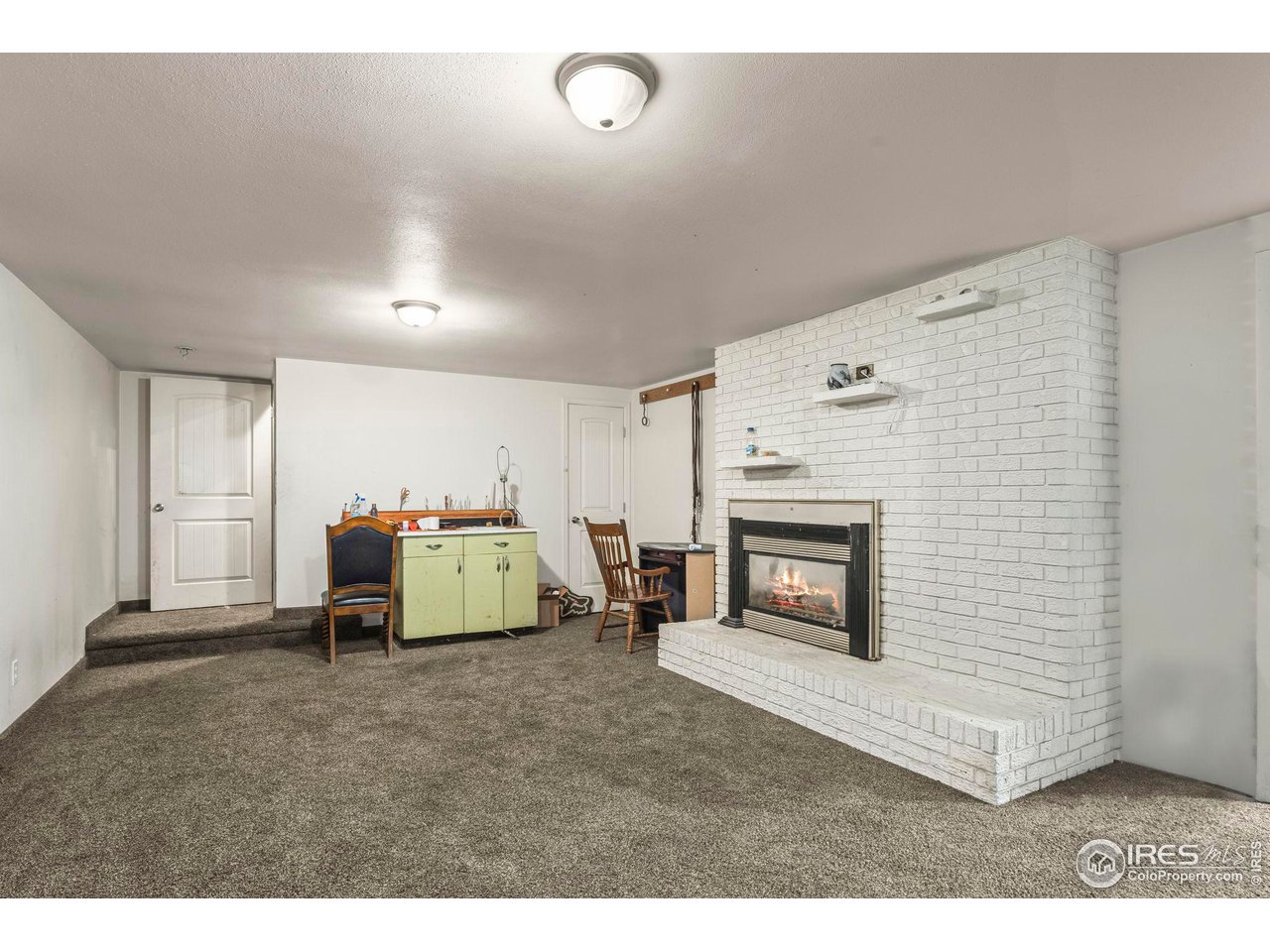 32864 County Road 49 Greeley, CO 80631 - Photo 27 of 40 a living room with furniture and a fireplace