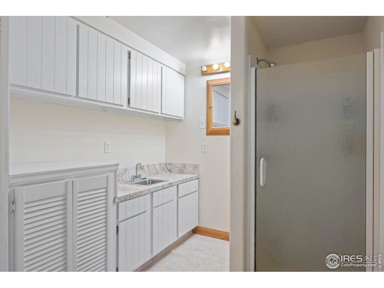 32864 County Road 49 Greeley, CO 80631 - Photo 32 of 40 a kitchen with a sink and cabinets