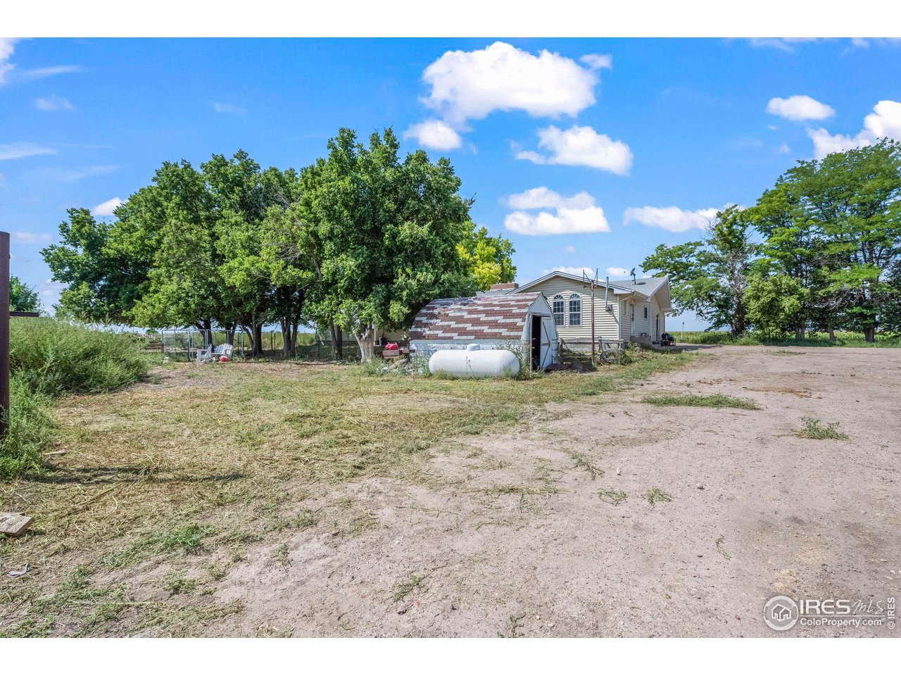 32864 County Road 49 Greeley, CO 80631 - Photo 34 of 40 a backyard of a house with lots of green space