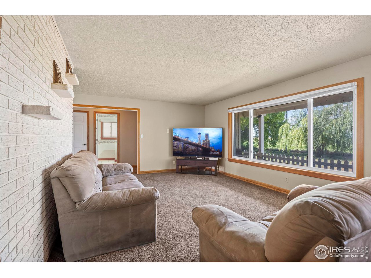 32864 County Road 49 Greeley, CO 80631 - Photo 4 of 40 a living room with furniture and a large window